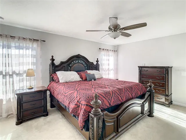 a spacious bedroom with a bed and a chandelier
