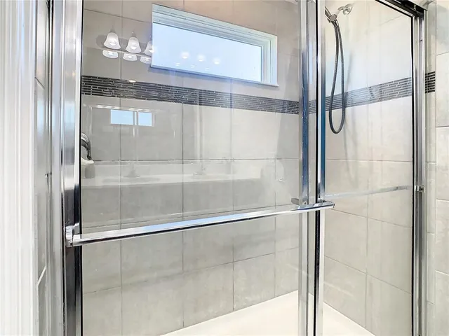 a bathroom with a glass shower door