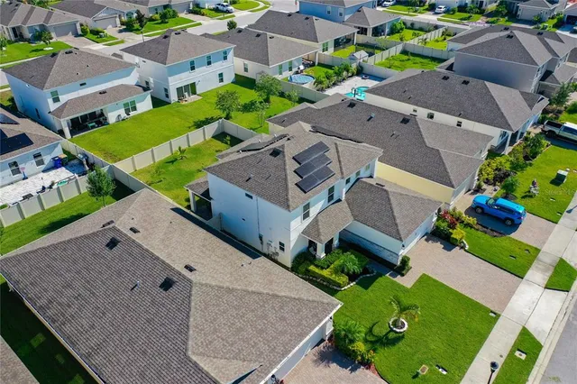 an aerial view of multiple houses with yard
