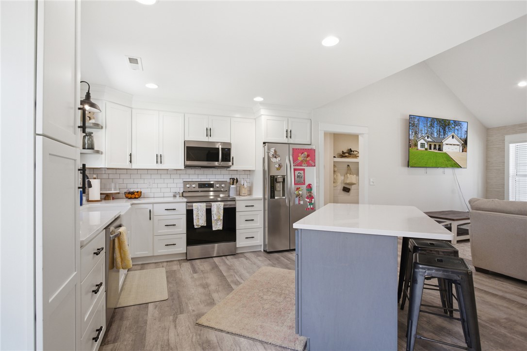 119 Brook Lane Seneca, SC 29672 - Photo 11 of 43 This bright kitchen features modern appliances, a large island, and durable flooring, perfect for daily living.