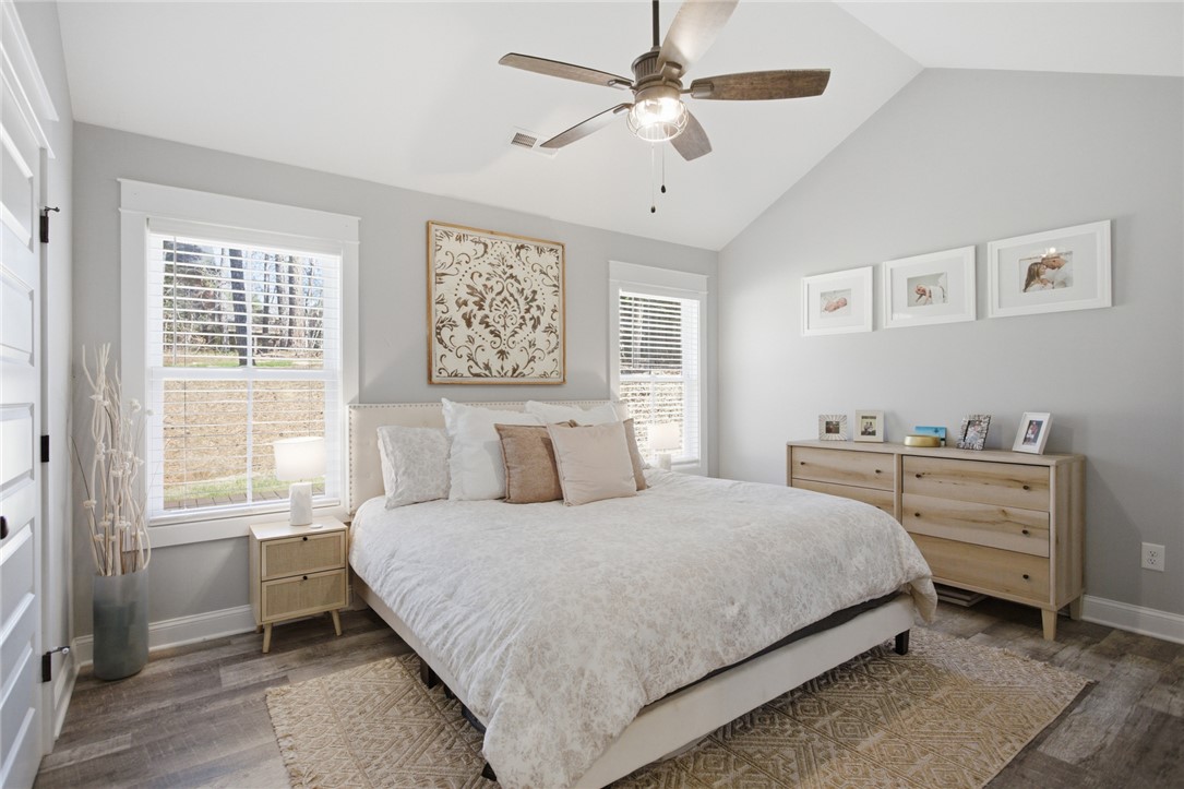 119 Brook Lane Seneca, SC 29672 - Photo 15 of 43 This serene bedroom offers high ceilings and large windows with elegant flooring, creating a comfortable retreat.