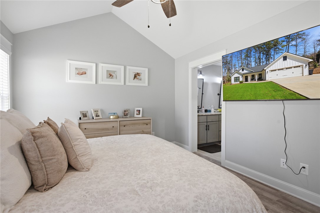119 Brook Lane Seneca, SC 29672 - Photo 16 of 43 This restful primary bedroom features a vaulted ceiling, seamlessly connecting to a private bath for ultimate comfort.