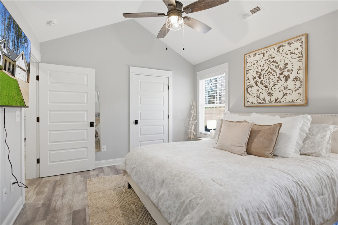 119 Brook Lane Seneca, SC 29672 - Photo 17 of 43 This spacious bedroom offers high ceilings and ample natural light, creating an airy and inviting atmosphere.