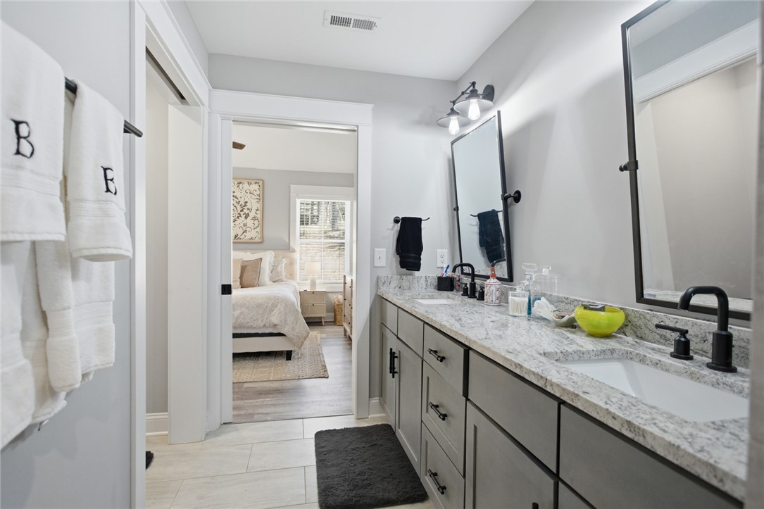 119 Brook Lane Seneca, SC 29672 - Photo 20 of 43 This primary bathroom features a double vanity and a granite countertop.