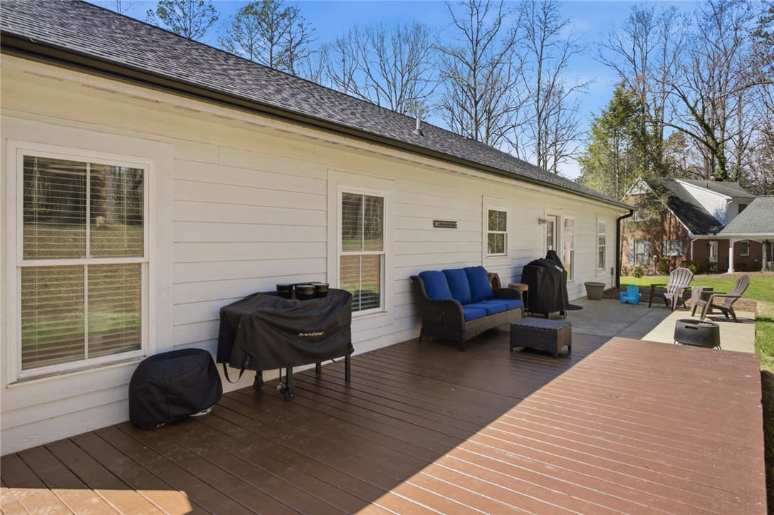 119 Brook Lane Seneca, SC 29672 - Photo 30 of 43 This inviting outdoor space features a spacious deck and patio area, ideal for relaxation and gatherings.