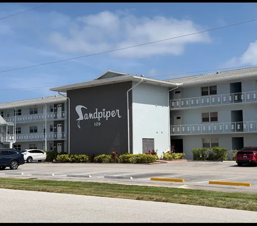 a front view of a building with parking