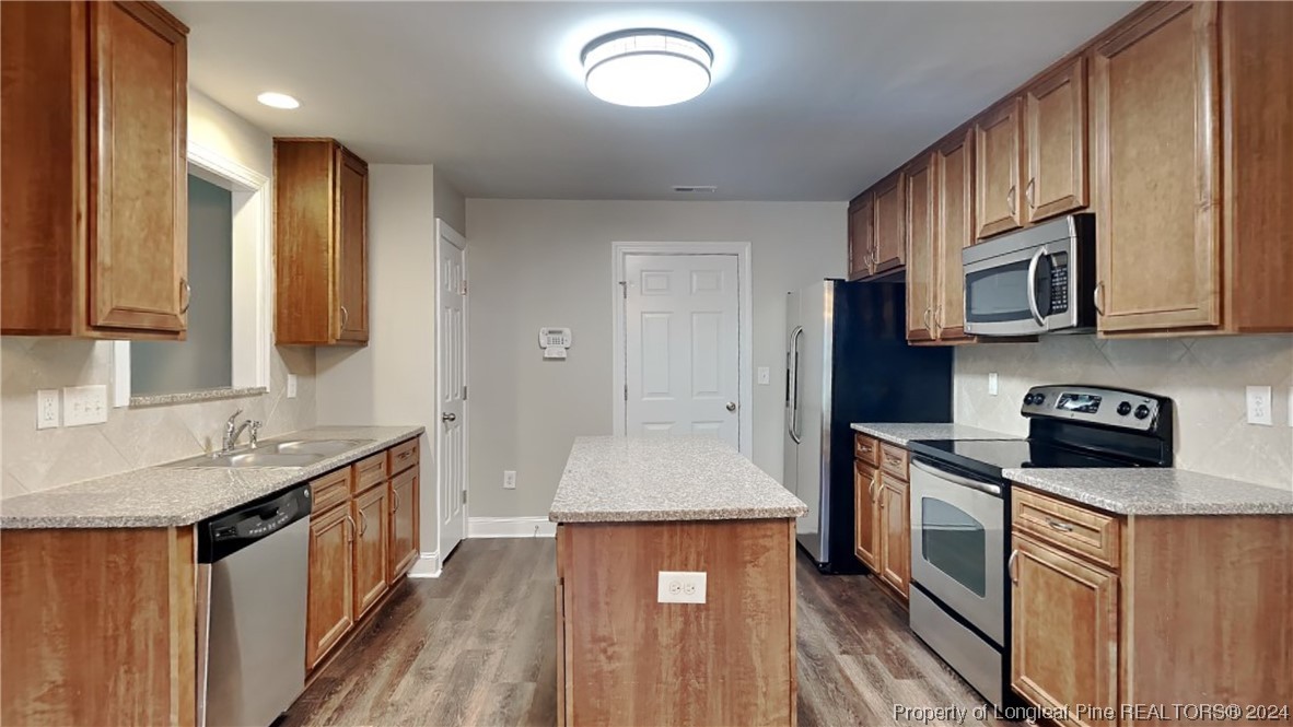 34 Huzzas Circle Cameron, NC 28326 - Photo 3 of 15 a kitchen with stainless steel appliances granite countertop a stove a sink dishwasher and a microwave oven with wooden floor