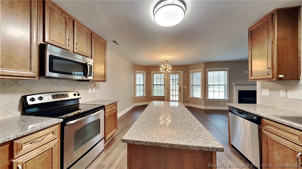 34 Huzzas Circle Cameron, NC 28326 - Photo 4 of 15 a kitchen with stainless steel appliances granite countertop a stove a sink and a microwave