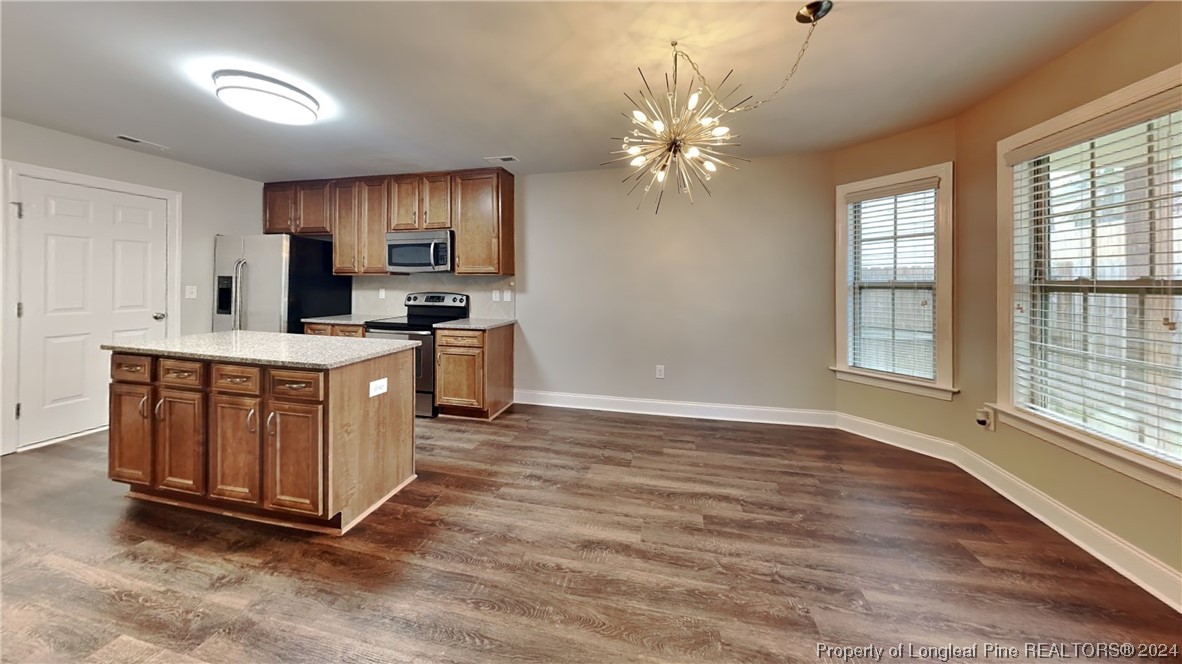 34 Huzzas Circle Cameron, NC 28326 - Photo 5 of 15 a kitchen with stainless steel appliances granite countertop a stove a sink dishwasher and a oven with wooden floor