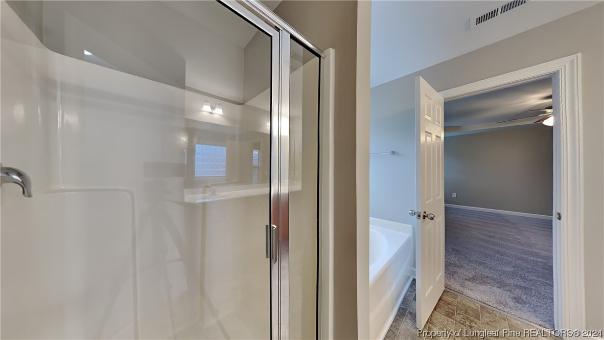34 Huzzas Circle Cameron, NC 28326 - Photo 7 of 15 a bathroom with a glass shower door
