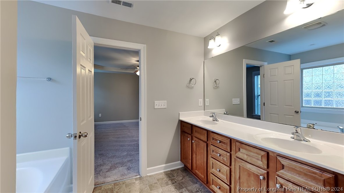 34 Huzzas Circle Cameron, NC 28326 - Photo 8 of 15 a bathroom with a sink double vanity and a tub