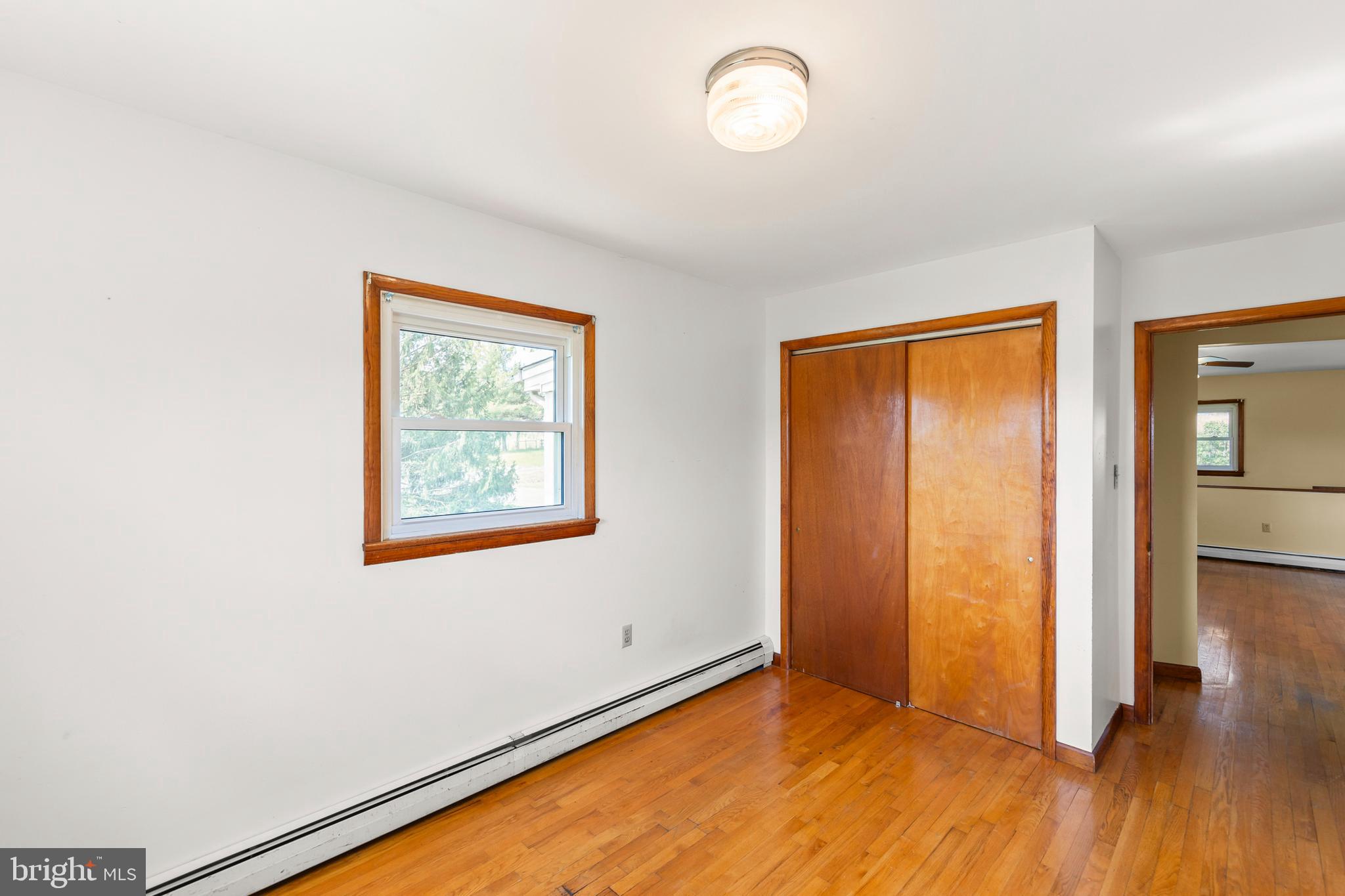 1156 Salem Church Road Stephens City, VA 22655 - Photo 12 of 37 an empty room with wooden floor and windows