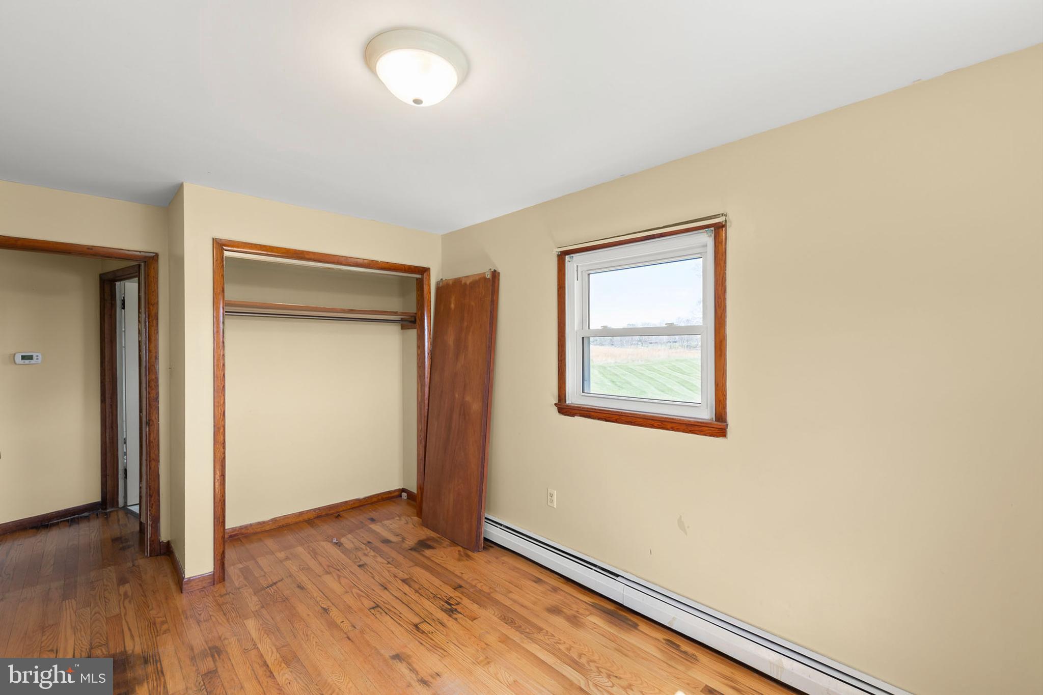 1156 Salem Church Road Stephens City, VA 22655 - Photo 15 of 37 an empty room with wooden floor and windows