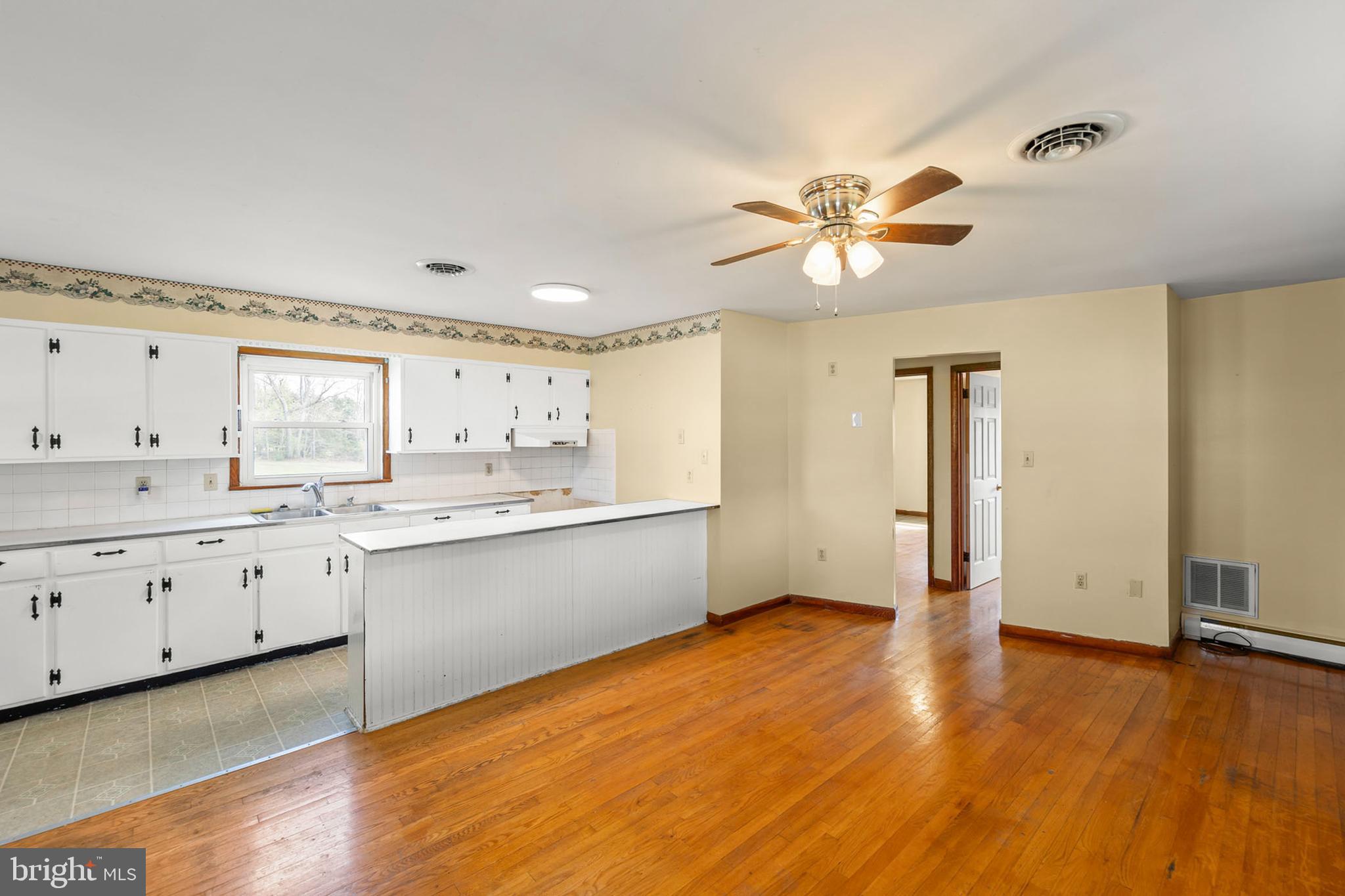 1156 Salem Church Road Stephens City, VA 22655 - Photo 5 of 37 a large kitchen with cabinets wooden floor and a ceiling fan