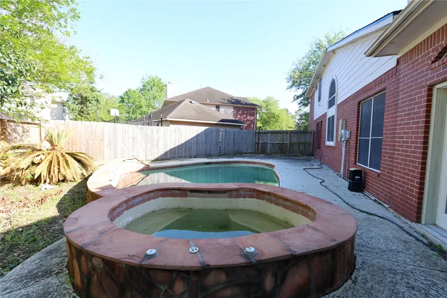 a small pool with trees in the background