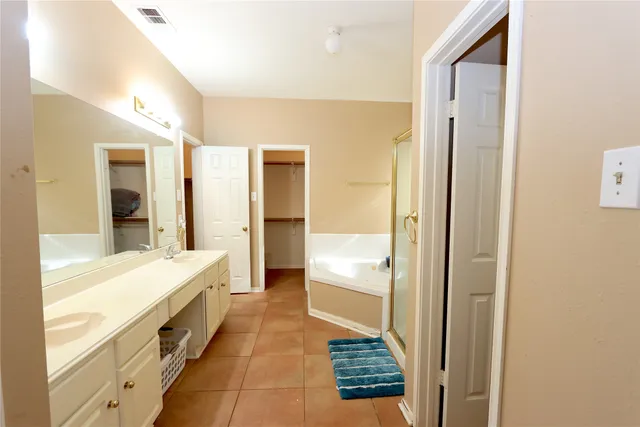 a bathroom with a tub and a sink