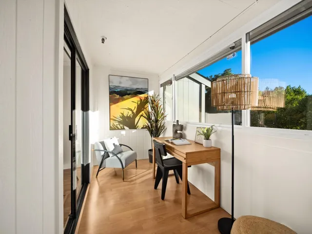 a dining room with furniture and a floor to ceiling window