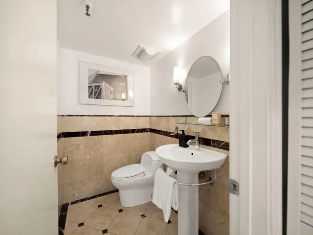 a bathroom with a sink mirror and toilet
