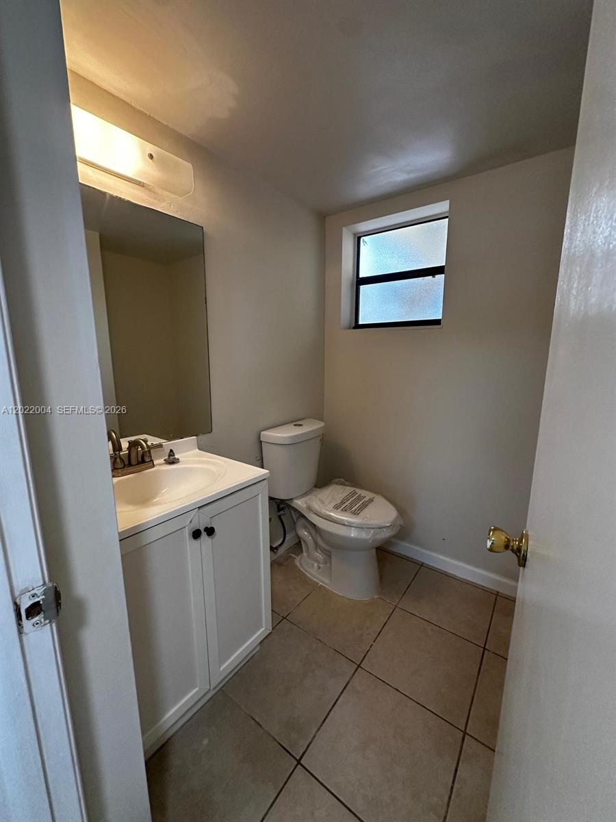 3400 Foxcroft Road, Unit 301 Miramar, FL 33025 - Photo 20 of 72 a bathroom with a toilet sink and mirror