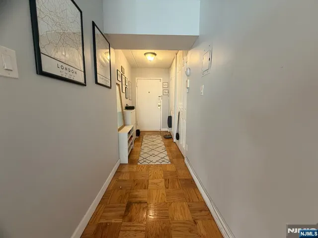 a view of a bathroom with mirror and shower