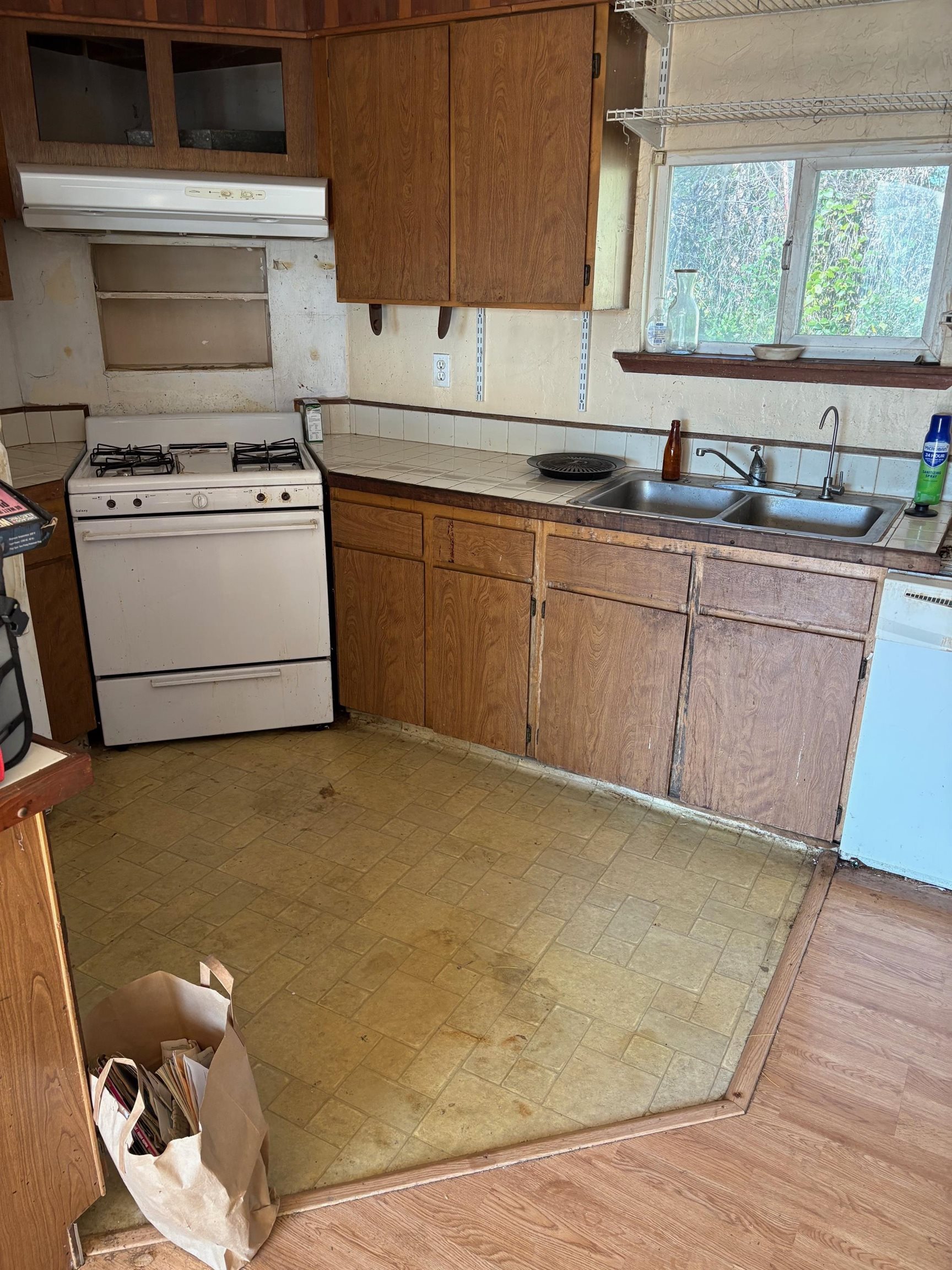 830 Shaws Flat Road Sonora, CA 95370 - Photo 8 of 11 Kitchen with white appliances, ventilation hood, tile counters, and brown cabinets