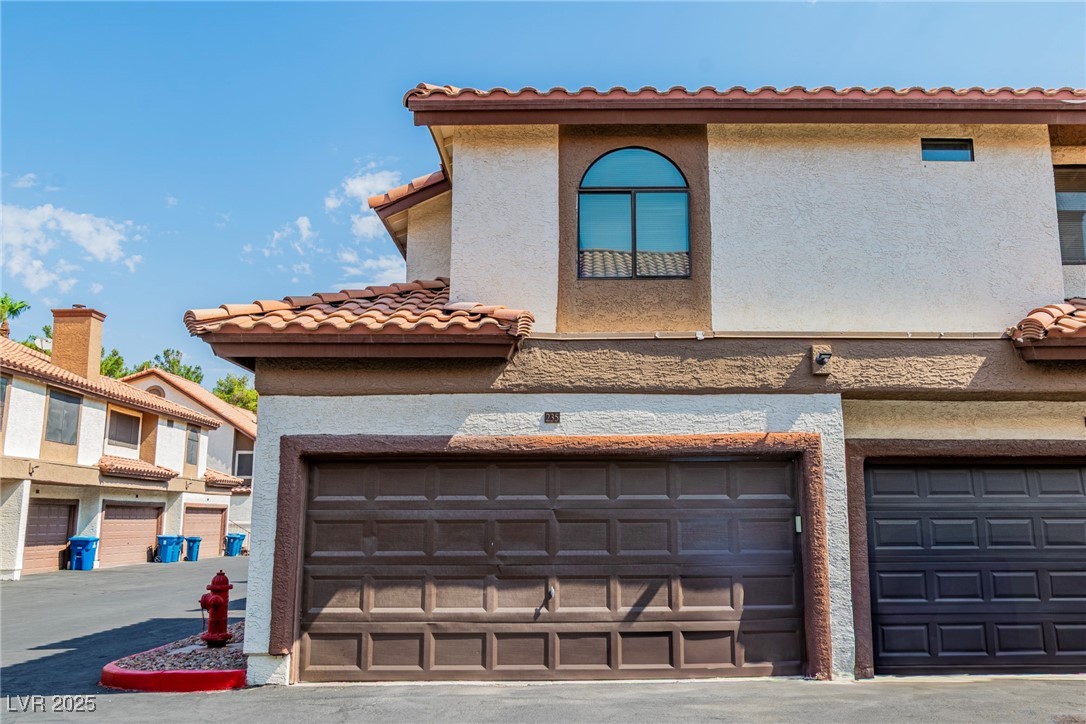2995 East Sunset Road, Unit 235 Las Vegas, NV 89120 - Photo 22 of 24 View of front of home with stucco siding and a 2 car garage