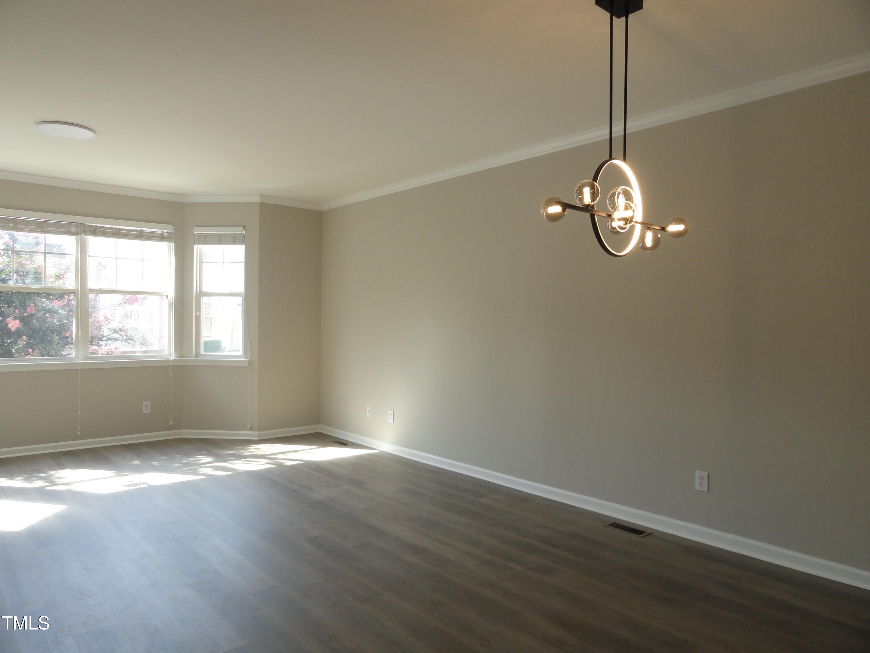 1531 Haywards Heath Lane Apex, NC 27502 - Photo 11 of 25 a view of empty room with window and wooden floor