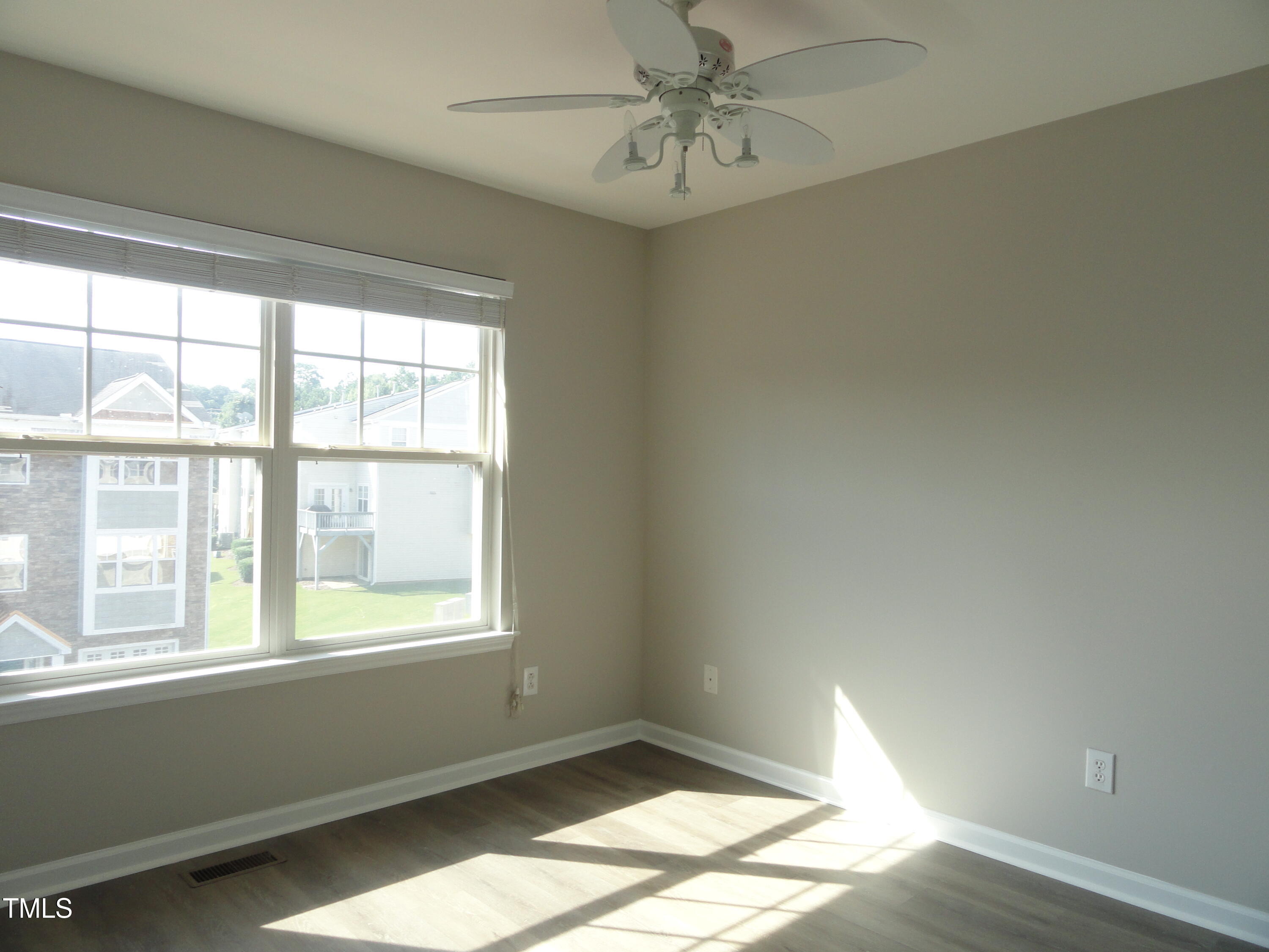 1531 Haywards Heath Lane Apex, NC 27502 - Photo 17 of 25 a view of empty room with wooden floor and fan