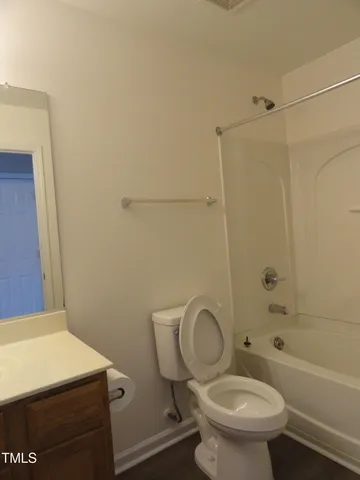 a white toilet sitting next to a bath tub