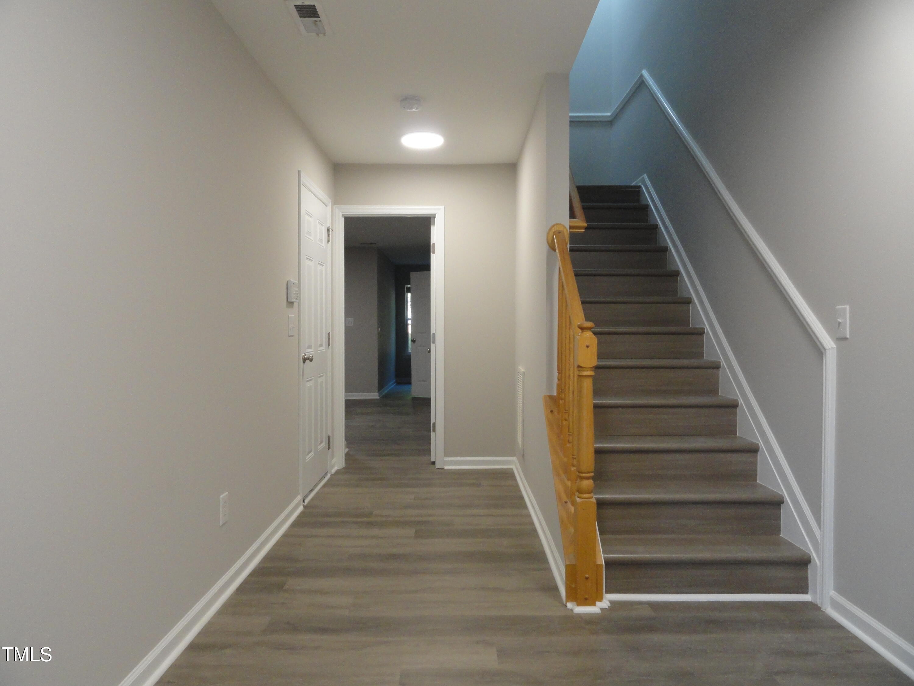 1531 Haywards Heath Lane Apex, NC 27502 - Photo 2 of 25 a view of a hallway with wooden floor and entryway