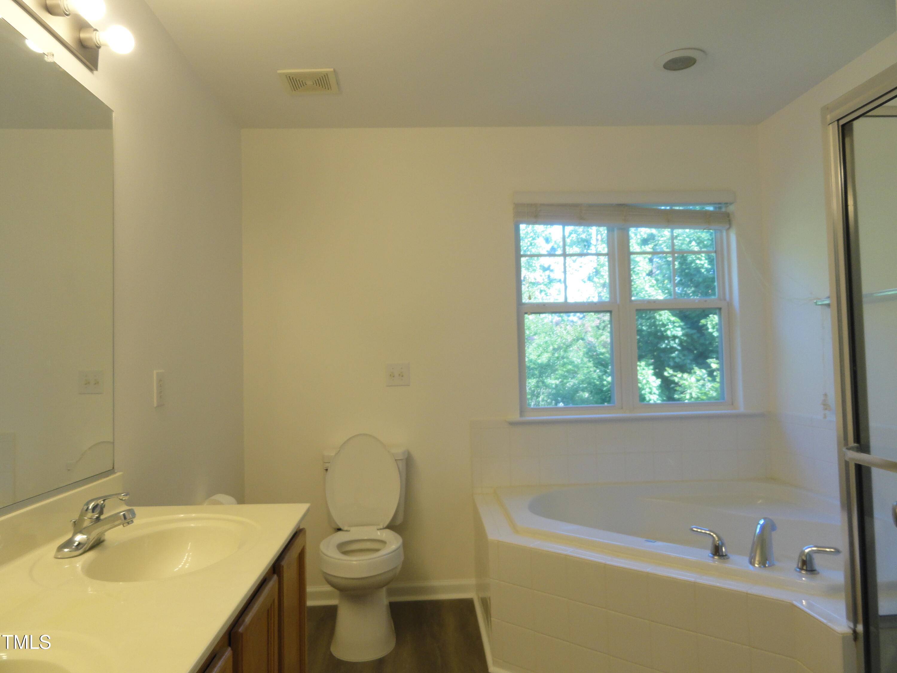 1531 Haywards Heath Lane Apex, NC 27502 - Photo 21 of 25 a bathroom with a sink a toilet and a bathtub