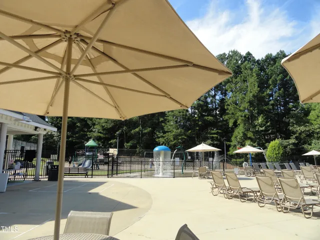 a view of a patio with a table and chairs under an umbrella