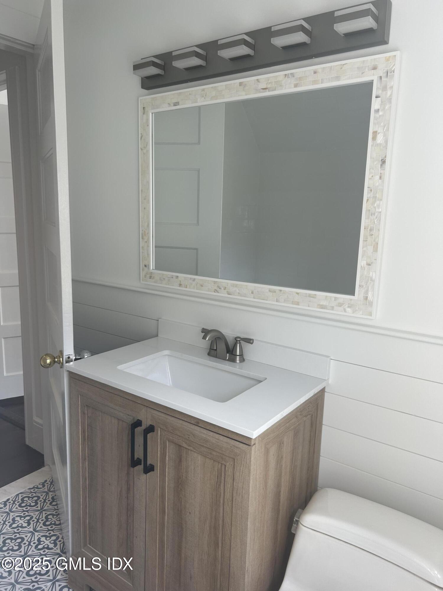 112 East Elm Street, Unit 1 Greenwich, CT 06830 - Photo 14 of 19 a bathroom with a sink and a mirror