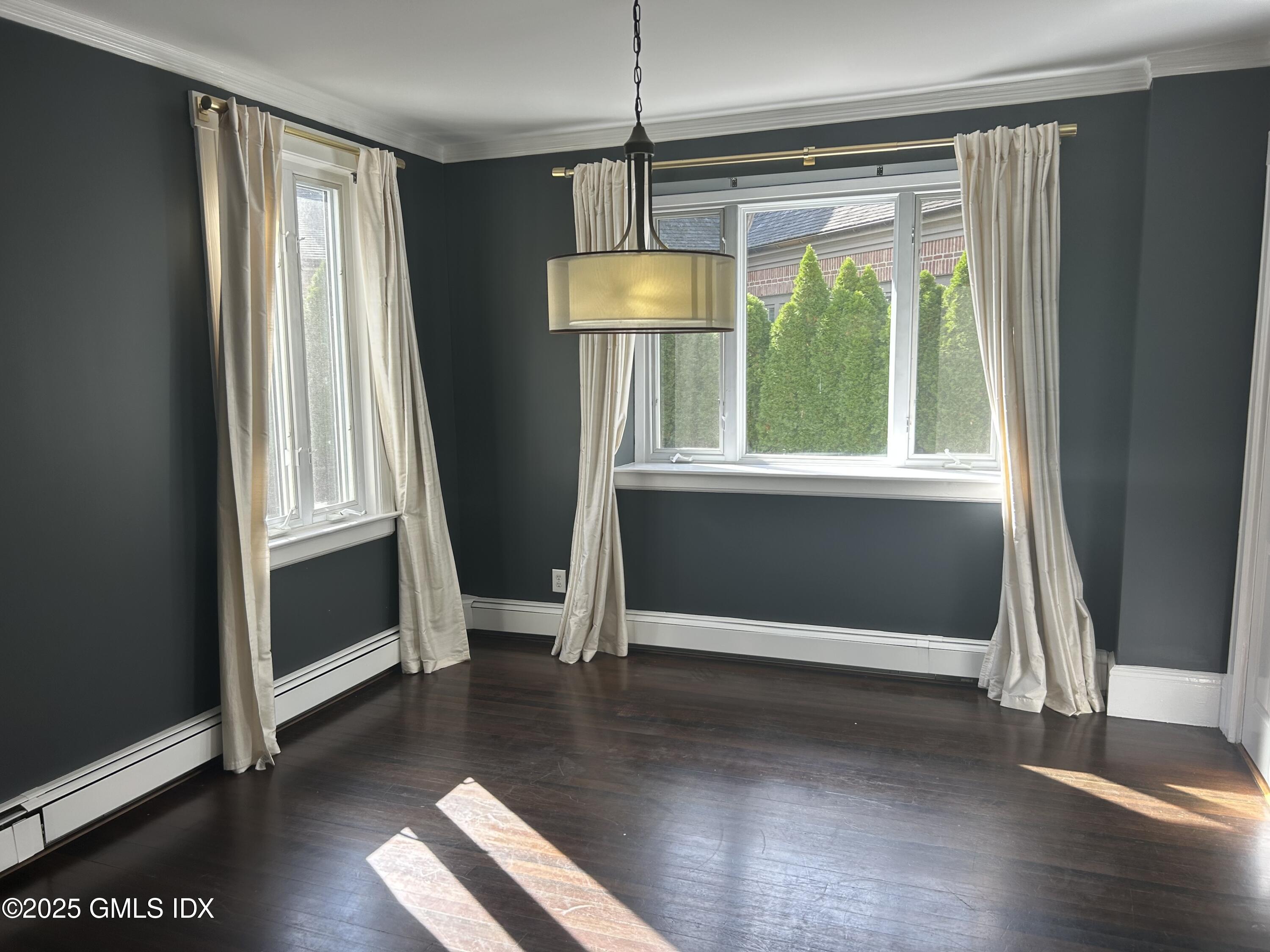112 East Elm Street, Unit 1 Greenwich, CT 06830 - Photo 3 of 19 a view of an empty room with wooden floor and a window