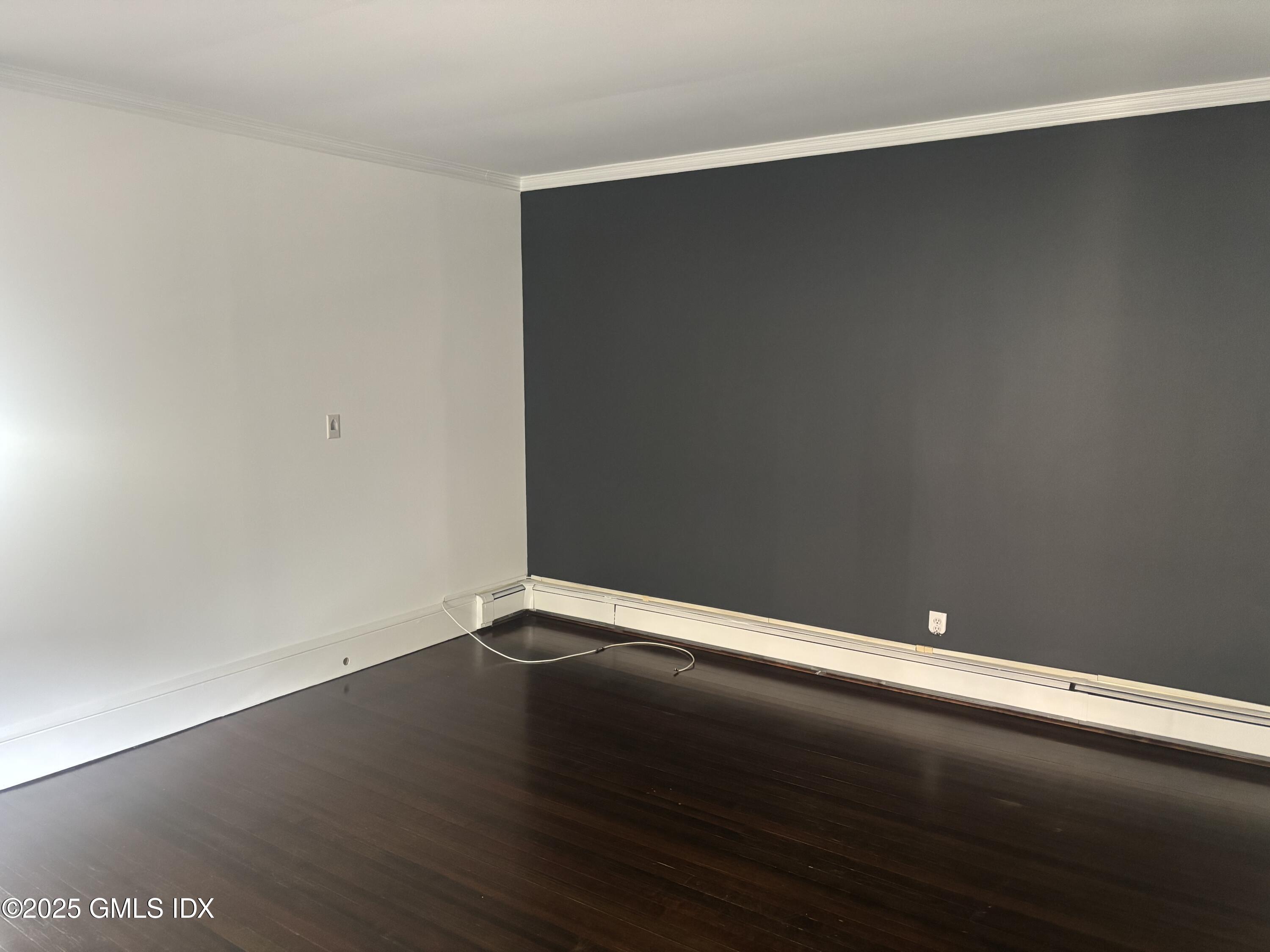 112 East Elm Street, Unit 1 Greenwich, CT 06830 - Photo 4 of 19 an empty room with wooden floor