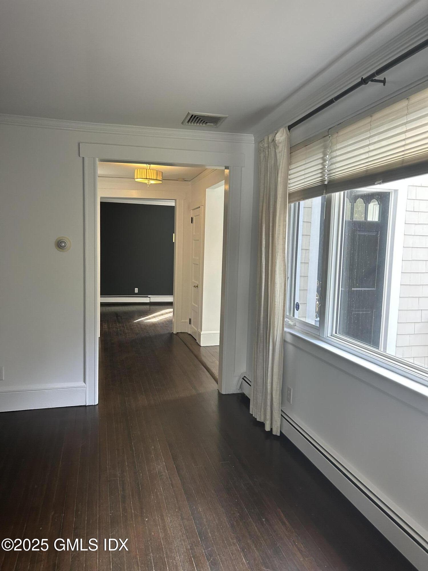 112 East Elm Street, Unit 1 Greenwich, CT 06830 - Photo 5 of 19 a view of a hallway with wooden floor and a living room