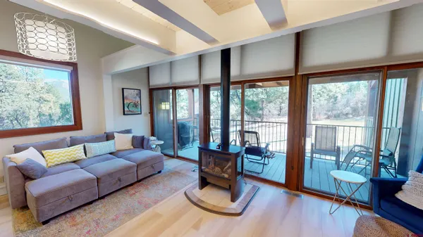 a living room with furniture and a floor to ceiling window