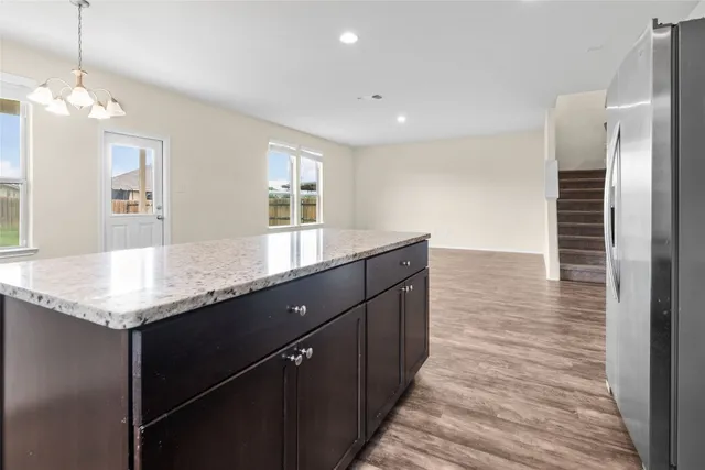 a view of a house with a big yard and large trees