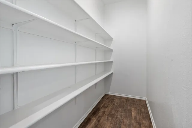 a bathroom with a granite countertop sink a mirror and a shower
