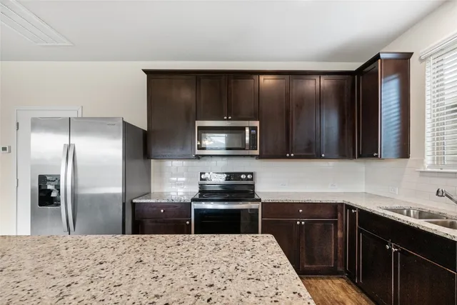 a kitchen with a refrigerator sink and microwave