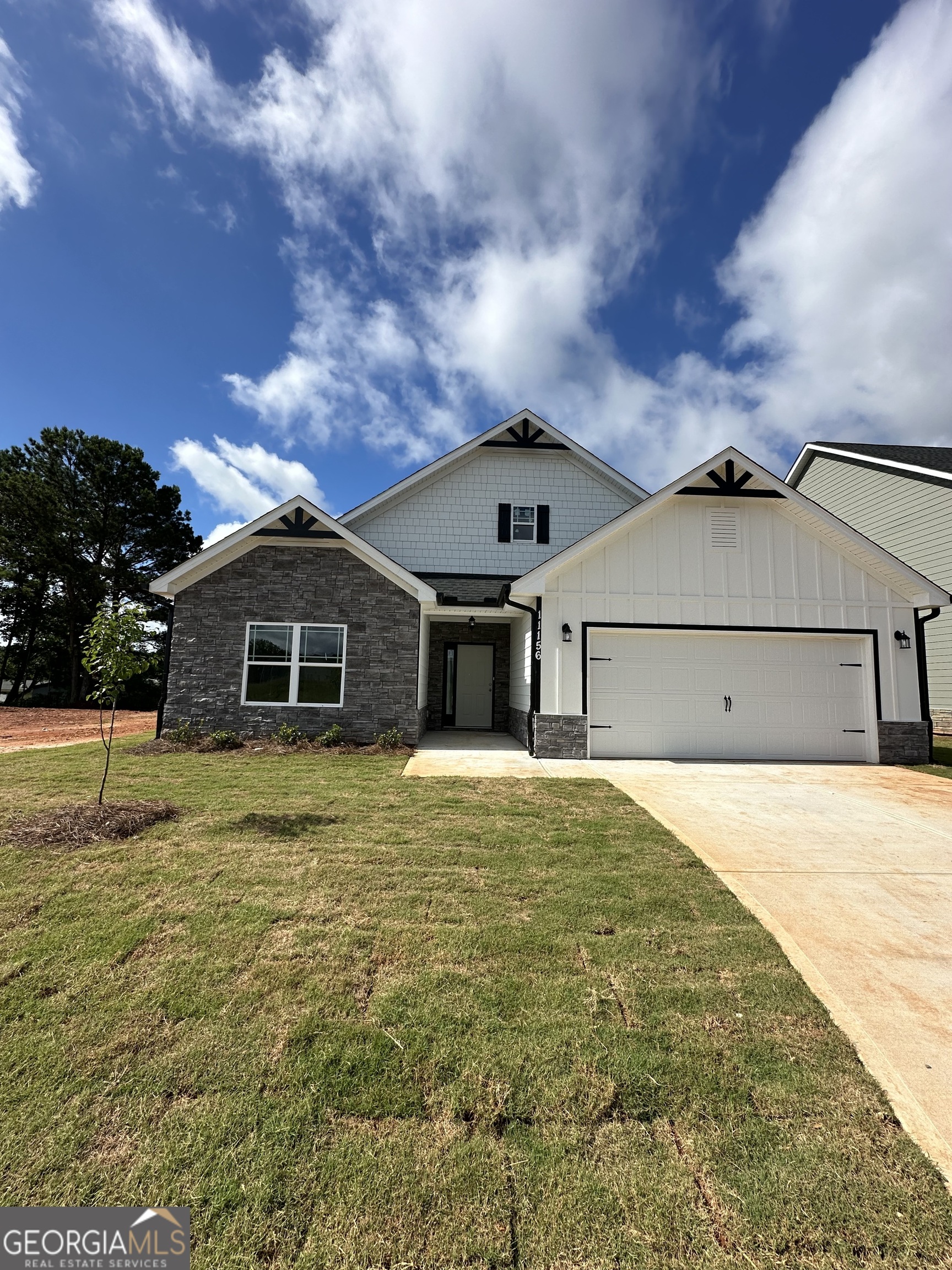 a front view of a house with a yard