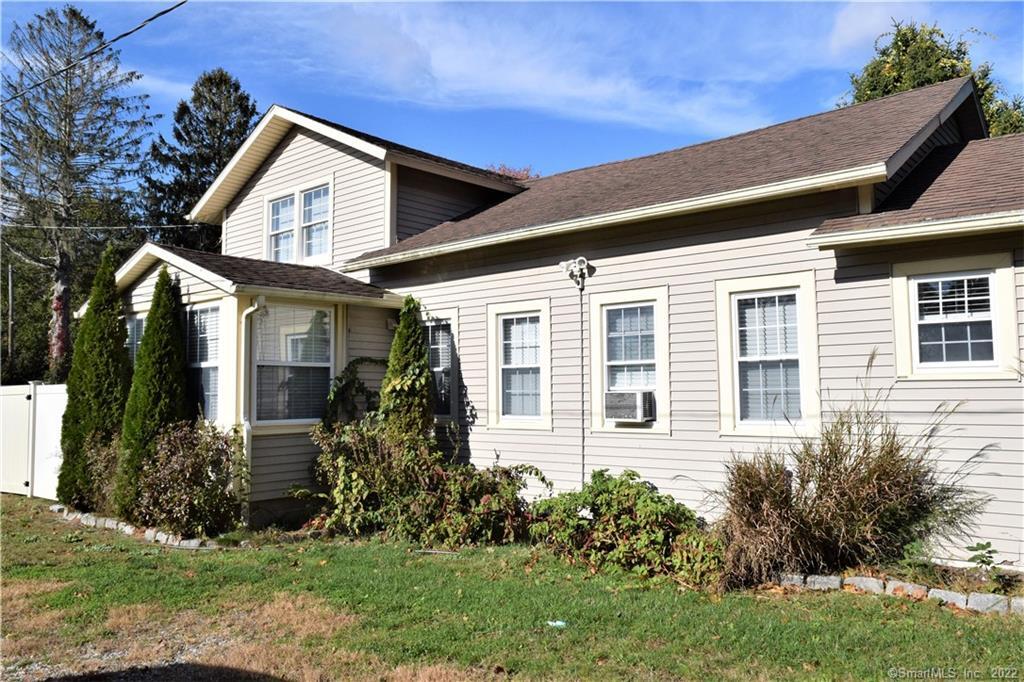 1306 Boston Post Road, Unit 1296 Westbrook, CT 06498 - Photo 1 of 1 a front view of a house with a yard