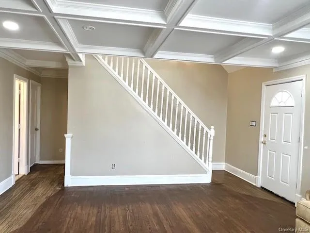 a view of an entryway with wooden floor