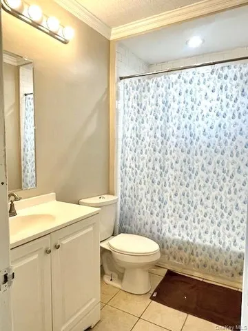 a white toilet sitting next to a shower curtain