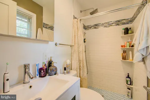 a bathroom with a sink and a shower curtain