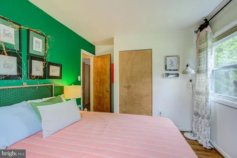 a bed room with a bed and a chair