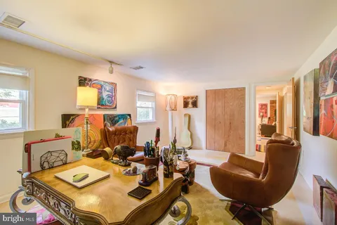a living room with furniture a rug and a window