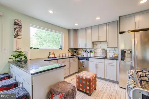 a kitchen with stainless steel appliances granite countertop a refrigerator sink and cabinets