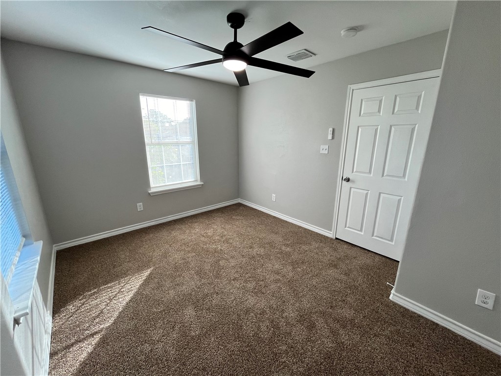 908 East Hefferman Street Beeville, TX 78102 - Photo 26 of 40 an empty room with windows and fan