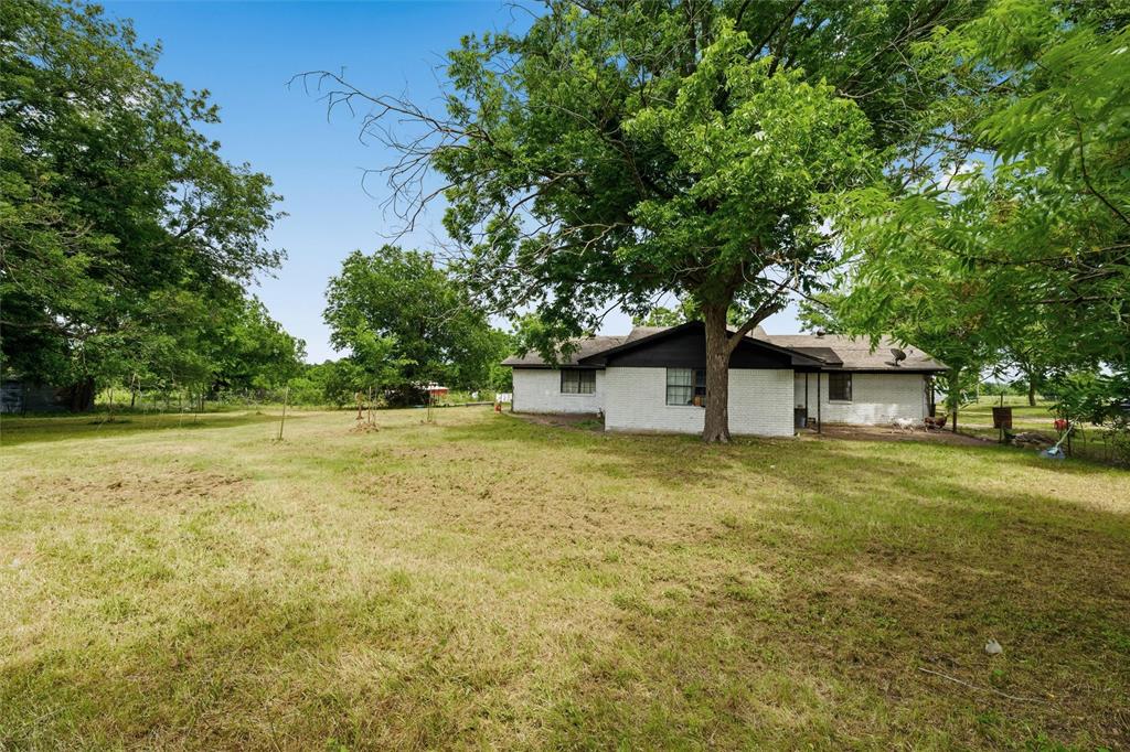 3122 Gun Club Road Temple, TX 76501 - Photo 3 of 22 a house is sitting in middle of the green field